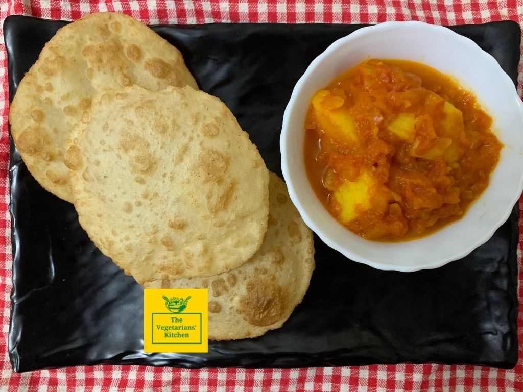 Three pieces of luchi served with potato curry 